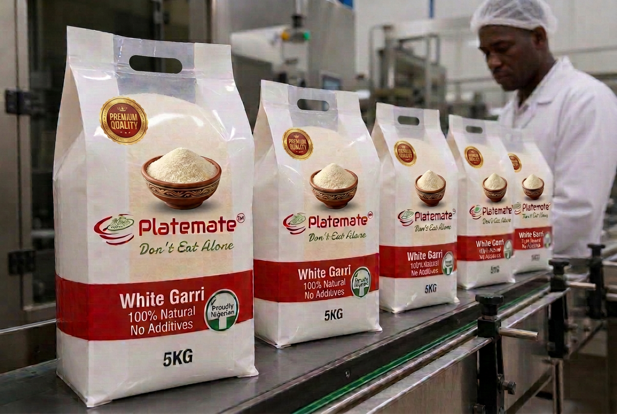 Upright 5KG Platemate garri bags with transparent product windows moving along the stainless-steel conveyor at the end of the production line